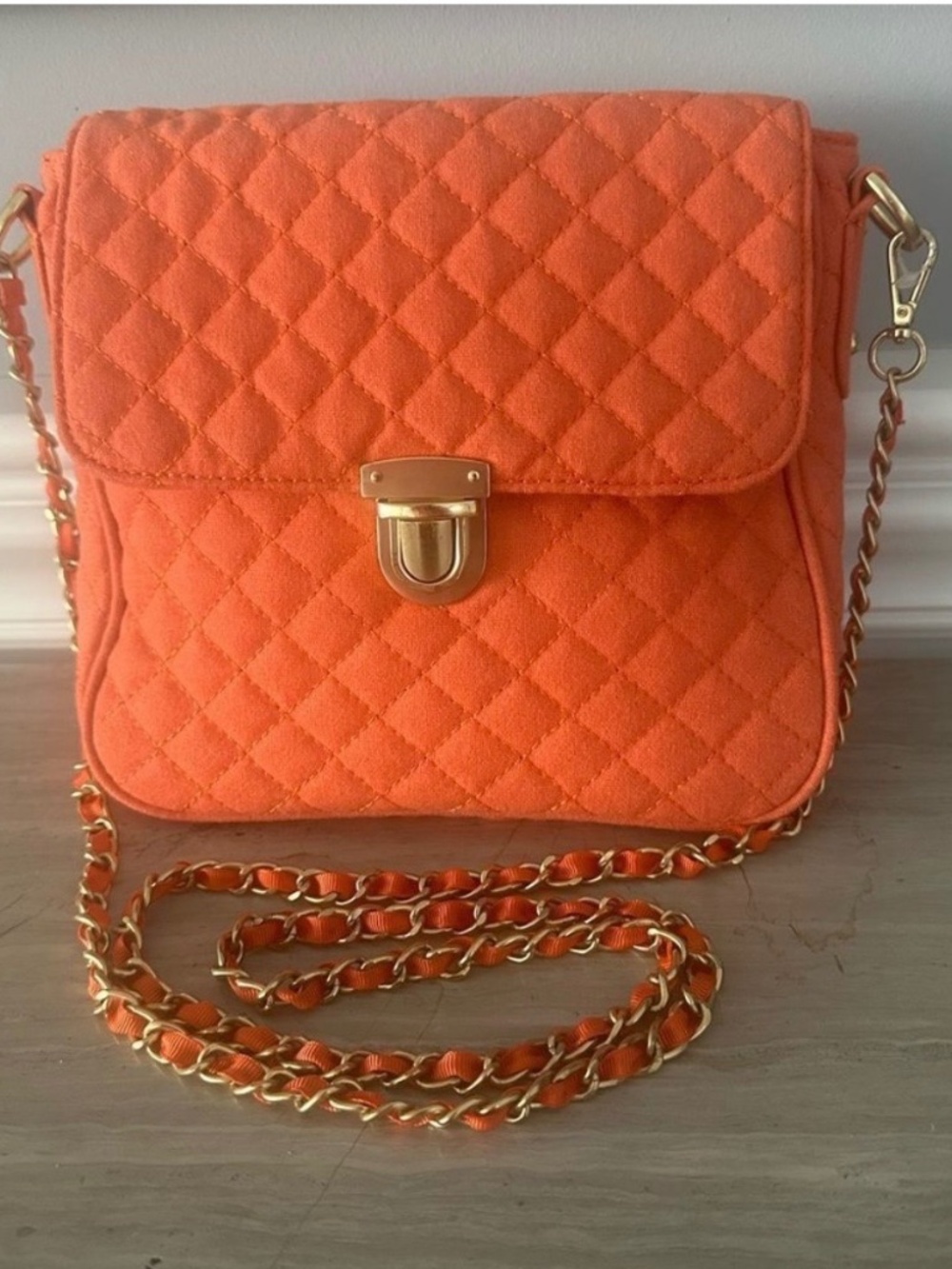 Chico’s orange, quilted crossbody bag.